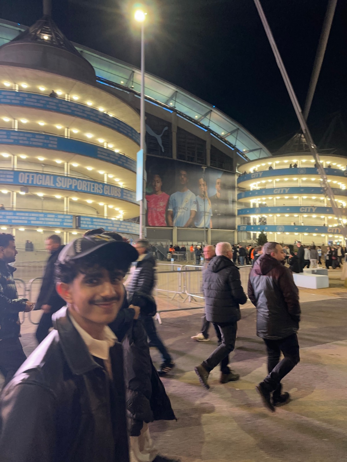 Crowd outside a stadium at night
