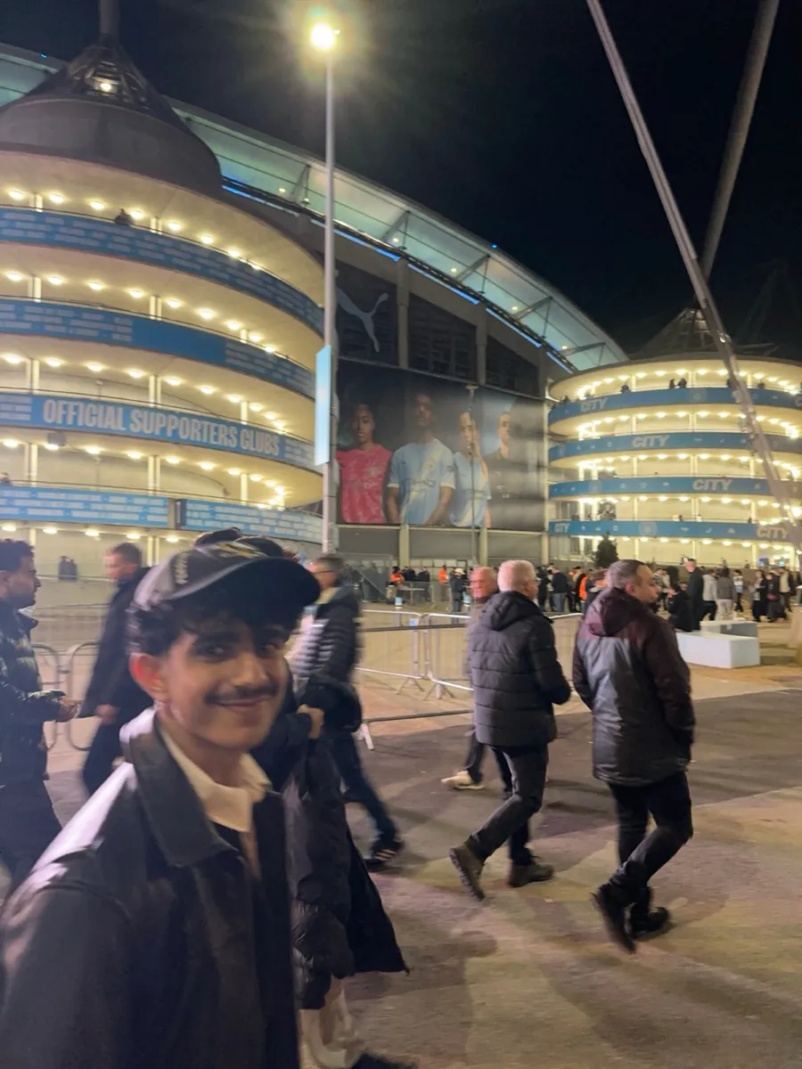 Crowd outside a stadium at night
